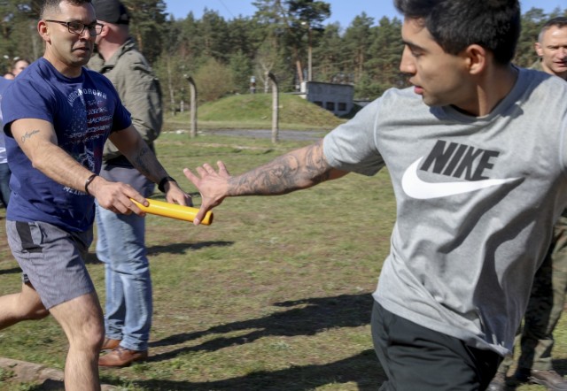 Sgt. 1st Class Juan Gonzales, 1st Armored Brigade Combat Team “IRONHORSE,” hands the baton to fellow IRONHORSE Trooper Spc. Joshua Padilla during a joint sports day between the U.S. and Polish at Zagan, Poland, April 27. The events, designed to build camaraderie, test fitness and strengthen partnerships, included 4x 400 meter relays, volleyball, weightlifting competitions, and a warrior fitness challenge. The sports day between IRONHORSE Troopers and their Polish counterparts is a part of Atlantic Resolve, where approximately 6,000 Soldiers are participating in nine-month rotations, enabling the U.S. to enhance deterrence, increase readiness and support NATO.