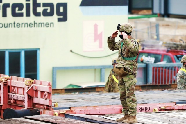 A U. S. Army Soldier assigned to the 1st Armored Brigade Combat Team, 1st Cavalry Division, gives hand and arm signals at Parsburg, Germany, Mar. 13, 2021.