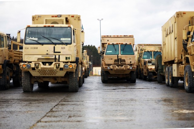 Vehicles assigned to the 1st Armored Brigade Combat Team, 1st Cavalry Division, are lined up at Hohenfels Training Area, Germany, in preparation for transfer to Poland, Mar. 11, 2021.