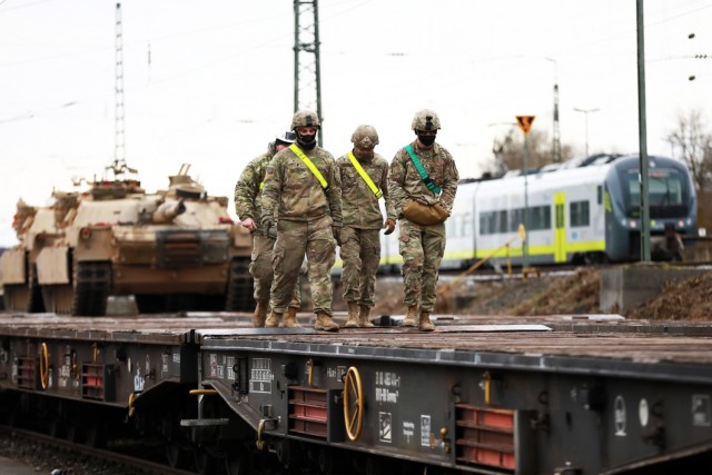 U.S. Army Soldiers assigned to the 1st Armored Brigade Combat Team, 1st Cavalry Division, walk on a railcar at Parsburg, Germany, Mar. 13, 2021.