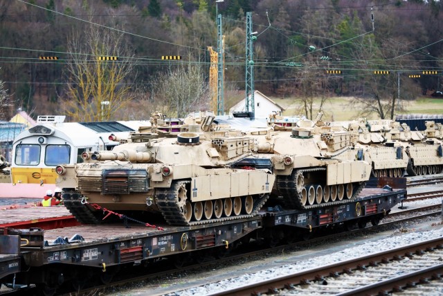 Two M1 Abrams Main Battle Tanks assigned to the 1st Armored Brigade Combat Team, 1st Cavalry Division, sit on railcars in preparation for transfer to Poland, at Parsburg, Germany, Mar. 13, 2021.