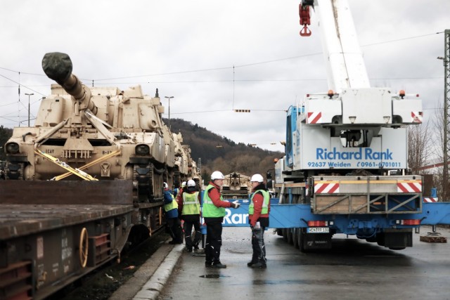 An M109 Paladin assigned to the 1st Armored Brigade Combat Team, 1st Cavalry Division, sits on a railcar in preparation for transfer to Poland at Parsburg, Germany, Mar. 11, 2021.