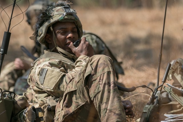 A U.S. Army Paratrooper assigned to 1st Brigade Combat Team, 82nd Airborne Division talks into a radio microphone at the Joint Readiness Training Center on Fort Polk, La., March 7, 2021. The Army is now fielding new network equipment to select Infantry Brigade Combat Teams while preparing the next upgrade, known as Capability Set 23. (U.S. Army photo by Sgt. Justin Stafford)