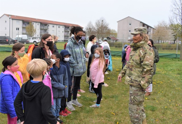Children at the Ansbach Child Development Center engage in conversation with USAG Ansbach Commander Col. Karen Hobart before planting trees on Arbor Day, April 30, 2021, together.