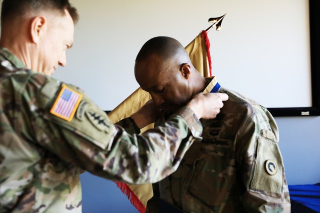 Col. Joseph Kurz, chief of staff, 1st Theater Sustainment Command, places the medal of the Honorable Order of Saint Martin Award on Lt. Col. Jermon Tillman, deputy of support operations, 1st TSC, at Fort Knox, Kentucky, April 30, 2021. To qualify for the Honorable Order, nominees must have demonstrated the highest standards of integrity and moral character. They must also have displayed an outstanding degree of professional competence, served the U.S. Army Quartermaster Corps with selflessness, and contributed to the promotion of the Quartermaster Corps in ways that stand out in the eyes of the recipient’s seniors, subordinates, and peers. (U.S. Army photo by Pfc. Kaylee Harris, Public Affairs)  ​