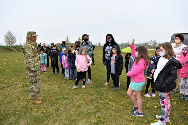 Children at the Ansbach Child Development Center engage in conversation with USAG Ansbach Commander Col. Karen Hobart before planting trees on Arbor Day, April 30, 2021, together.