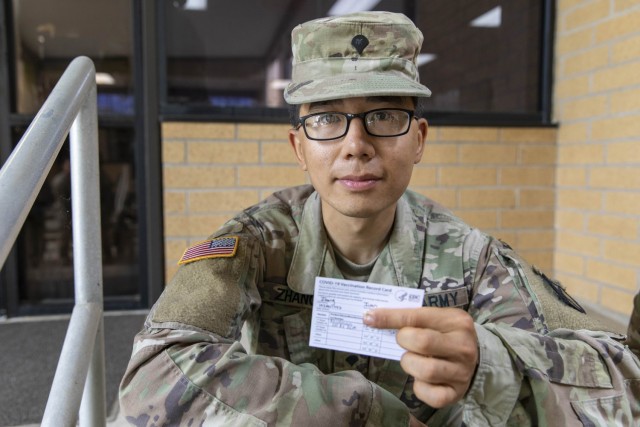 U.S. Army Specialist Ivan Zhang, an intel analyst assigned to Headquarters and Headquarters Company, 2nd Battalion, 30th Infantry Regiment, 3rd Brigade Combat Team, 10th Mountain Division, shows off his COVID-19 Vaccination Record Card after receiving the first does of the Moderna vaccine at the Joint Readiness Training Center and Fort Polk Soldier Readiness Program building, Fort Polk, Louisiana, April 28, 2021. In preparation for an upcoming deployment to Afghanistan, Soldiers from 2-30 Infantry Regiment were offered the vaccine. (U.S. Army photo by Staff Sgt. Ashley M. Morris)