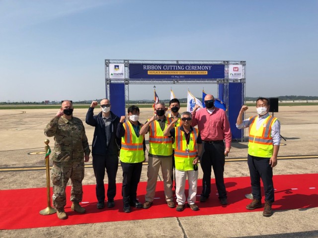 Col. Christopher Crary (Left), U.S. Army Corps of Engineers (USACE), Far East District (FED) commander and members of the FED Project Delivery Team attended a ribbon cutting ceremony for the replacement of the main runway on Osan Air Base,...