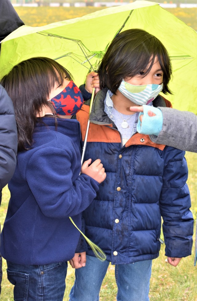 Children brave the rain during the Arbor Day event April 30, 2021 at the USAG Ansbach CYS playground.