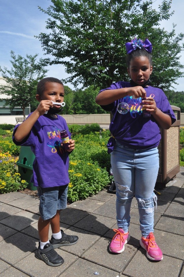 Nine-year-old Zimiah Olszak and her little brother blow bubbles as part of Martin Army Community Hospital's Month of the Military Child celebration.