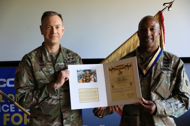Col. Joseph Kurz, chief of staff, 1st Theater Sustainment Command, and Lt. Col. Jermon Tillman, deputy of support operations, 1st TSC, stand together after Tillman was awarded the Honorable Order of Saint Martin Award at Fort Knox, Kentucky, April 30, 2021. To qualify for the Honorable Order, nominees must have demonstrated the highest standards of integrity and moral character. They must also have displayed an outstanding degree of professional competence, served the U.S. Army Quartermaster Corps with selflessness, and contributed to the promotion of the Quartermaster Corps in ways that stand out in the eyes of the recipient’s seniors, subordinates, and peers. (U.S. Army photo by Pfc. Kaylee Harris, Public Affairs)