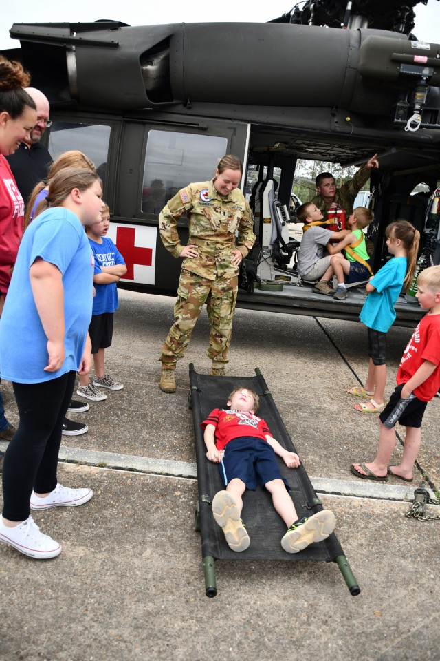 Above: 1st Lt. Katie Rummery, Cajun Dustoff pilot, looks on as Calvin Walker gets on the litter to try it out.