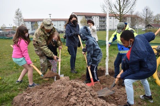 Col. Karen Hobart, garrison commander, helps with the shoveling at the USAG Ansbach CYS playground on Arbor Day, April 30, 2021.