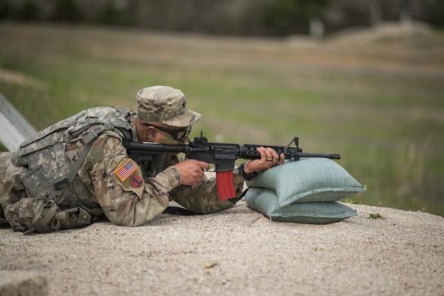 Staff Sgt. Marco Apodaca, competing in the NCO of the Year category, engages with targets during a rifle qualification event April 27 on Range 22.