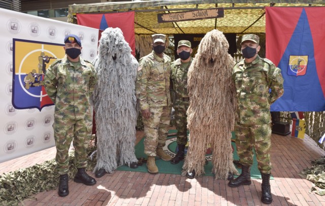 Command Sgt. Maj. Sean Rice, center, senior enlisted advisor at U.S. Army Security Assistance Command, poses for a photo with Colombian snipers and senior enlisted leaders during day 4 of a key leader engagement with the Colombian Army at the Canton Norte base in Bogota, Colombia, 8 April 2021. CSM Rice joined Brig. Gen. Douglas Lowrey, USASAC commander, and members of his staff, as they visited several sites to see the impact of U.S. security assistance and foreign military sales, in support of the Colombian military in defending their country from counter-narcotic and terrorist threats. (U.S. Army photo by Richard Bumgardner)