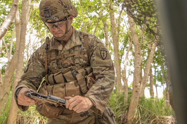 Maj. Chris Mattos, Headquarters and Headquarters Battalion, 25th Infantry Division, assembles a M17 pistol on Schofield Barracks, Hawaii, April 28, 2021, for the Expert Soldier Badge/Expert Infantry Badge competition. The EIB/ESB is reserved for Soldiers possessing military occupational specialties of infantryman or special forces, while the Expert Soldier Badge is open to the remainder of Soldiers aside from medics and it tests Soldiers’ abilities on basic soldiering skills in an intense competition.