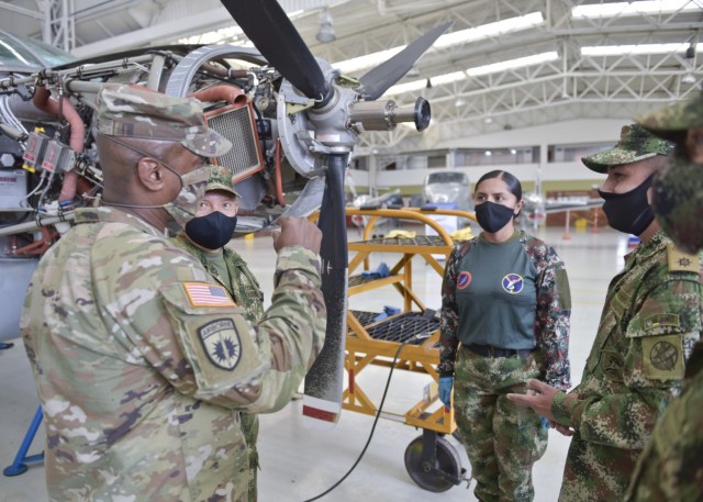 Command Sgt. Maj. Sean Rice, senior enlisted advisor at U.S. Army Security Assistance Command, talks with soldiers assigned to the aviation maintenance unit of the Colombian Army base in Tolemaida, Colombia, 6 April 2021. CSM Rice joined Brig. Gen.Douglas  Lowrey, and members of his staff, as they visited several sites to see the impact of U.S. security assistance and foreign military sales, in support of the Colombian military in defending their country from counter-narcotic and terrorist threats. (U.S. Army photo by Richard Bumgardner)