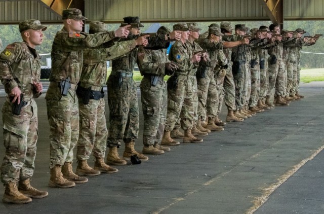 Competitors familiarize themselves with the requirements to draw and fire their weapon before the stress shoot event April 28 at Range 13.