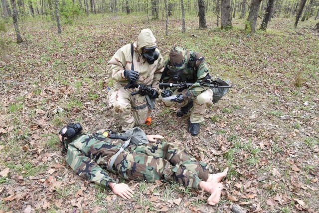 A team responds to a simulated casualty while patrolling during a chemical reaction lane April 27 at Training Area 125.