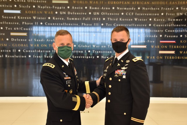Col. Andrew R. “Drew” Morgan receives the Army astronaut device from Lt. Gen. Daniel L. Karbler, commanding general of U.S. Army Space and Missile Defense Command, during a May 5 ceremony at the National Museum of the United States Army at Fort Belvoir, Virginia. (Photo by Ronald Bailey)