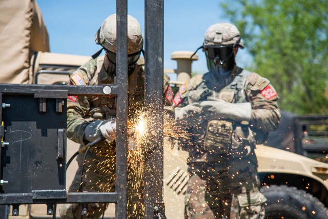 Sgt. 1st Class Timothy Wolber and Staff Sgt. Tyler Adams complete a thermal breach May 1 near Forney Airfield during the Round Robin events.