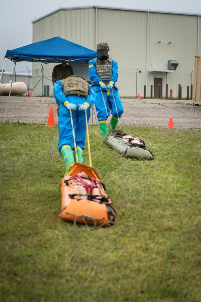 A team drags simulated casualties at one of six stations testing CBRN knowledge and soldiering skills April 29 outside the Chemical Defense Training Facility.