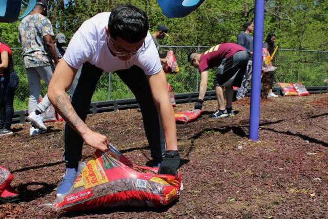 Pvt. Justin Melendez, information technology specialist, 1st Theater Sustainment Command, spreads mulch on the playground at SpringHaven Domestic Violence Shelter in Elizabethtown, Kentucky, April 30, 2021. Melendez, along with his fellow Soldiers from the 1st TSC G-6 section, volunteered beautifying the grounds in support of Sexual Assault Awareness and Prevention Month.