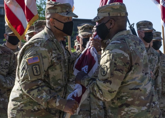 Brig. Gen. Shan Bagby, incoming commander, accepts the colors from Lt. Gen. R. Scott Dingle, U.S. Army Medical Command commanding general and The Surgeon General, during the Regional Health Command-Central Change of Command Ceremony at the AMEDD Museum Amphitheater on Joint Base San Antonio-Fort Sam Houston May 5.