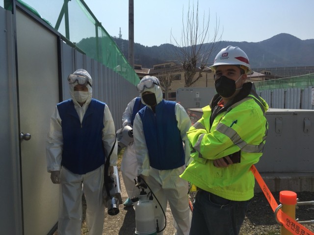 Jared McCormick, Southern Resident Office resident engineer, monitors the Camp Walker Family Housing Towers construction site clean team, at USAG Daegu, South Korea, April 3, 2020. (courtesy photo)