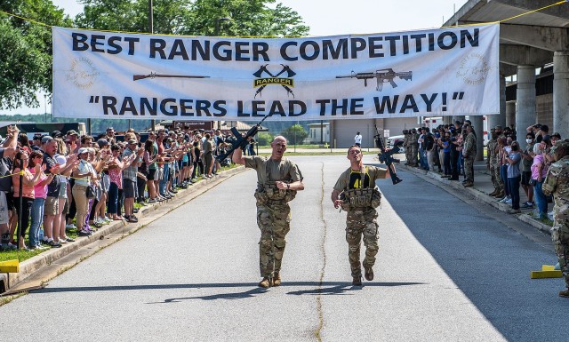 Majs. Matthew Snyder, an instructor in the Department of Military Instruction, and Will Fuller, an instructor at the Department of Physical Education, gave their all during the final stretch of the culminating two-mile run during 37th annual David...