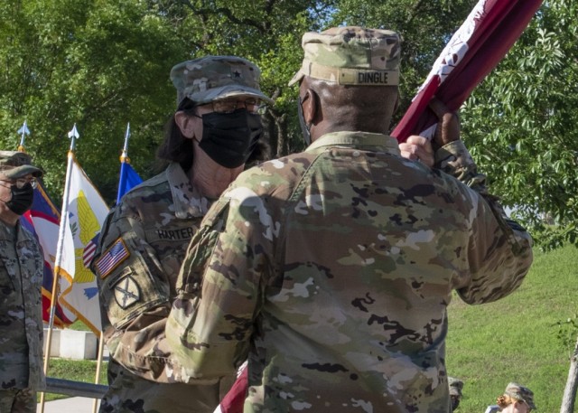 Outgoing commander, Brig. Gen. Wendy L. Harter, passes the colors to Lt. Gen R. Scott Dingle, commander of U.S. Army Medical Command and The Surgeon General, during the Regional Health Command-Central change of command ceremony May 5 on Joint Base...