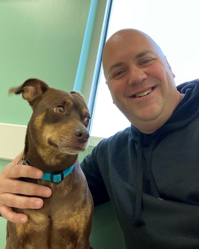Staff Sgt. Thomas Reilly, a Soldier assigned to the Fort Belvoir Soldier Recovery Unit, Va., posed with Bo at a new pet care facility on base where he currently volunteers. (Photo courtesy of Staff Sgt. Thomas Reilly)