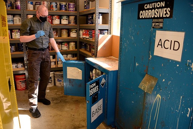 Michael Goble, Household Hazardous Waste manager, looks in one of the cabinets containing corrosive liquids May 5 at the HHW site at 810 McClellan Ave. Any common-use chemicals used in the home, such as paint, cleaners, personal care products and...