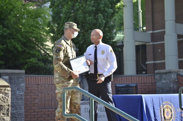 Corporal Bradley Dardas assigned to 2nd Battalion, 506th Infantry Regiment, 3rd Brigade Combat Team, 101st Airborne Division (Air Assault), receives a citizen commendation April 30 from Clarksville Police Department Chief David Crockarell for...