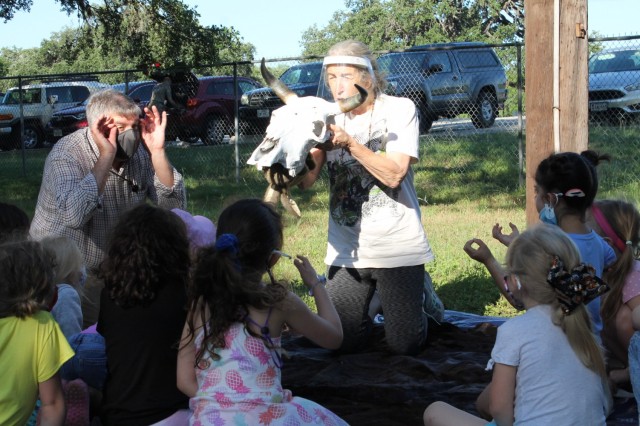 Fran Coulter (left) and Pat Gonser explain the difference between predator eyes and prey eyes at the Skins and Skulls station during the U.S. Army Environmental Command Nature Walk held for about 140 kindergarteners from the Fort Sam Houston Elementary School. Coulter is a geologist, and Gonser is a retired school teacher and spouse of a USAEC employee.