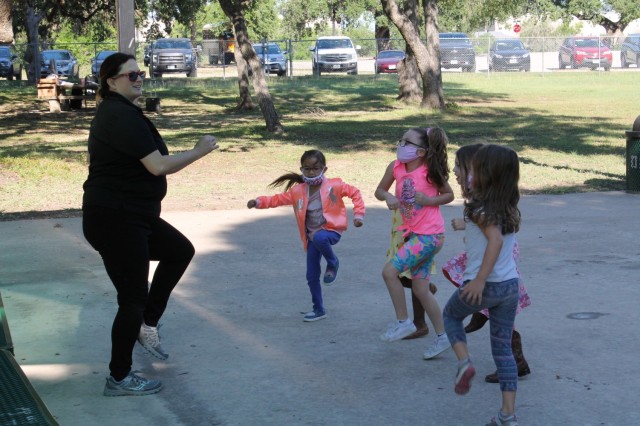 Jennifer Rawlings, an environmental scientist, leads a group of children in an exercise during the U.S. Army Environmental Command Nature Walk held for about 140 kindergarteners from the Fort Sam Houston Elementary School.