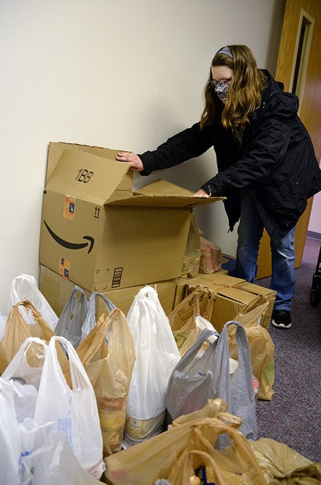 Sara Hanley, Patton Junior High School seventh-grader, moves donated food items, collected during her "passion project" food drive, to load them for transport to the Leavenworth Mission Community Store/Food Pantry after school April 28 at Patton....
