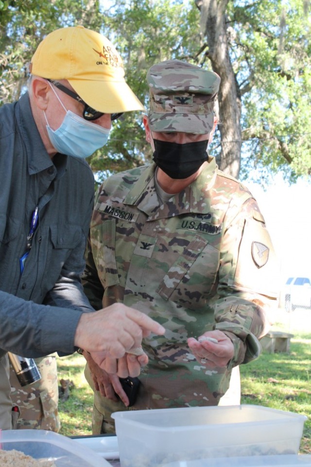 Scott Weber, a geologist, explains geometric patterns and stratification to Col. Alicia M. Masson, USAEC commander, during the U.S. Army Environmental Command Nature Walk held for about 140 kindergarteners from the Fort Sam Houston Elementary School.