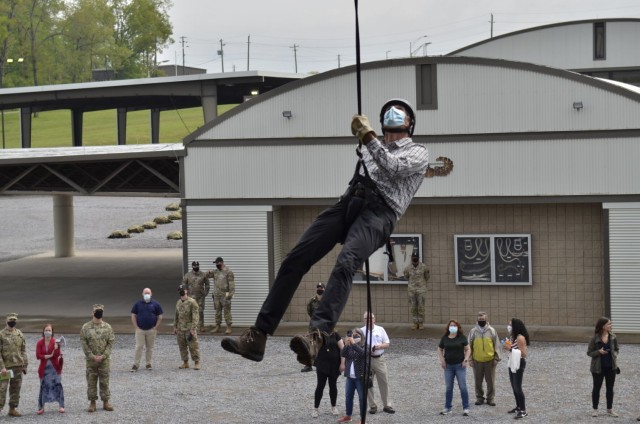Ben Rooke, regional president of Brasfield & Gorrie, rappels down a 34-foot tower at The Sabalauski Air Assault School April 28 while on a Nashville Leaders Tour of Fort Campbell.