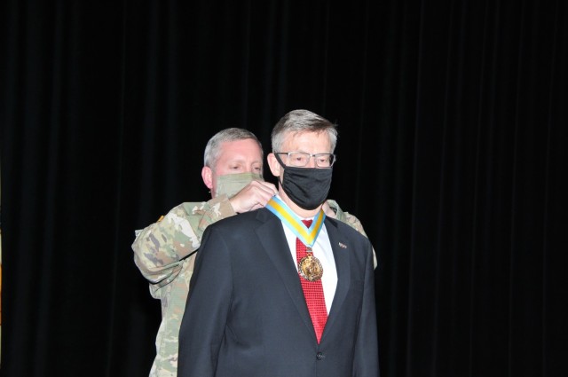 Timothy Goddette (foreground), outgoing Program Executive Officer, Combat Support and Combat Service Support, received the National Infantry Association’s Order of St. Maurice from Col. William Venable, Project Manager-Stryker Brigade Combat Team Program Executive Office Ground Combat Systems at Goddette’s Relinquishment of Leadership Ceremony at the Detroit Arsenal, Mich. May 4. 