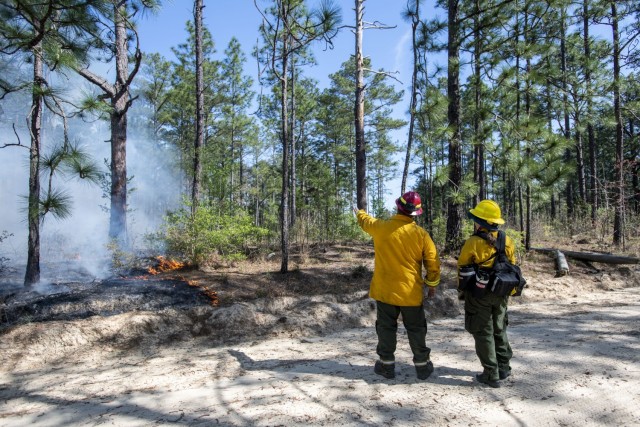 Ian Smith, fire management officer, Forestry Branch, shows Michelle Wilcox, wildlife biologist, where she'll be working during controlled burns on Fort Jackson, April 13.