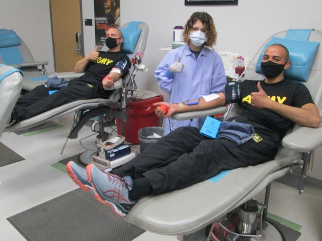 Macayla Tompkins, Fort Leonard Wood Blood Donor Center phlebotomist, helps two Fitness Training Unit Soldiers donate blood to the Armed Services Blood Program March 30.