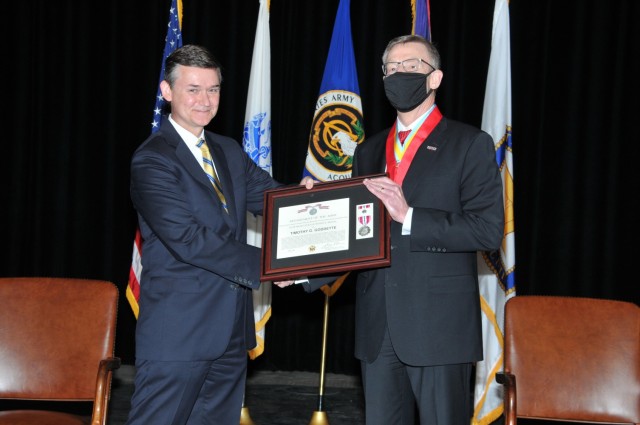Douglas Bush (left), Acting Assistant Secretary of the Army for Acquisition, Logistics, and Technology, presented Timothy Goddette (right), outgoing Program Executive Officer, Combat Support and Combat Service Support, the Superior Civilian Service Medal during his Relinquishment of Leadership Ceremony at the Detroit Arsenal, Mich. May 4. 