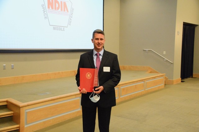 Retired Col. Christopher Ingels receives a Leadership Award during the National Defense Industrial Association’s awards dinner April 27. The award recognizes his work for Army Materiel Command prior to retirement. His last assignment in his...