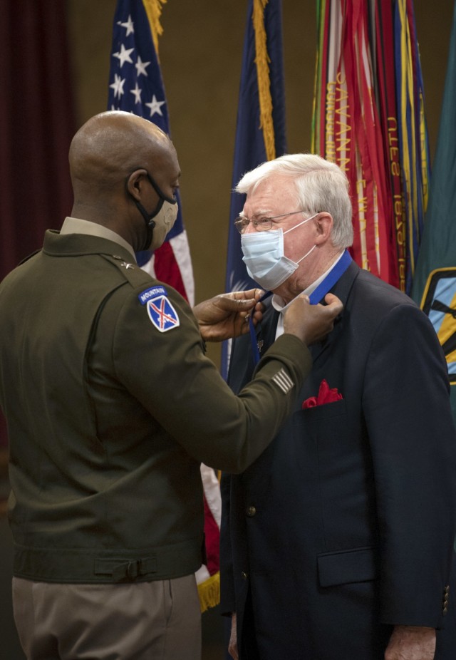 Fort Jackson Commander Brig. Gen. Milford H. 'Beags' Beagle Jr. places a ribbon around the neck of Joe Pinner during Pinner's induction into the Fort Jackson Hall of Fame April 22 at the NCO Club on post.