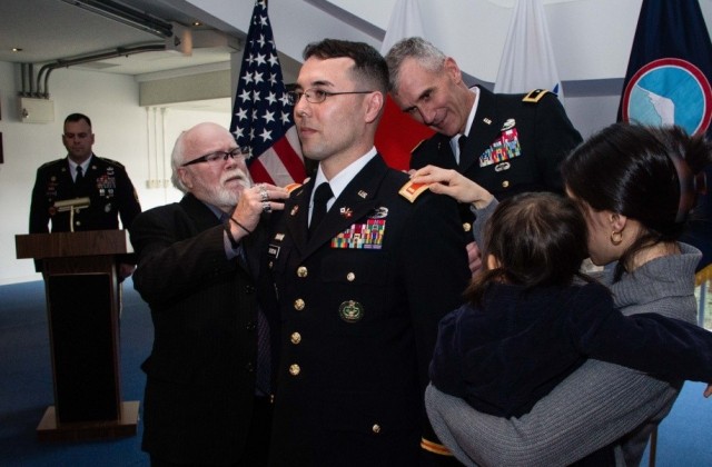Newly promoted Army 2nd Lt. Riki R. Riordan, a signal officer with 311th Signal Command, stands at attention as his father, Patrick, left, and his wife, Miyuki, right, pin second lieutenant bars on their son and husband&#39;s shoulders during a direct commission ceremony conducted Jan. 6, 2016, at Camp Zama, Japan. Recruiters plan to carry out a mass recruiting drive starting May 10 through June 14 to add future officers and enlisted Soldiers to its pool of talent. 