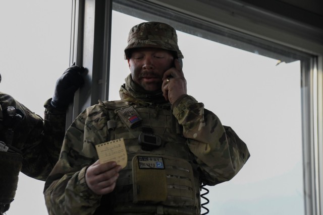 A British soldier assigned to Charlie Battery, 3rd Regiment, Royal Horse Artillery, communicates grid coordinates at the Tapa Training Grounds, Estonia, May 5, 2021. U.S. Army Soldiers from B Battery, 1st Battalion, 77th Field Artillery Regiment, 41st Field Artillery Brigade, and United Kingdom soldiers from the Royal Horse Artillery conduct a Multiple Launch Rocket System live-fire exercise. This live-fire exercise was the kick-off event for Fires Shock, a series of exercises designed to enhance readiness and interoperability by providing credible, long-range precision fires at any given time. This portion of Fires Shock was in support of Swift Response 21, a linked exercise of DEFENDER-Europe 21. DEFENDER-Europe 21 is a large-scale U.S. Army-led exercise designed to build readiness and interoperability between the U.S., NATO allies, and partner militaries. This year, more than 28,000 multinational forces from 26 nations will conduct nearly simultaneous operations across more than 30 training areas in more than a dozen countries from the Baltics to the strategically important Balkans and Black Sea Region. Follow the latest news and information about DEFENDER-Europe 21, visit www.EuropeAfrica.army.mil/DefenderEurope.(U.S. Army photo by Spc. Denice Lopez)