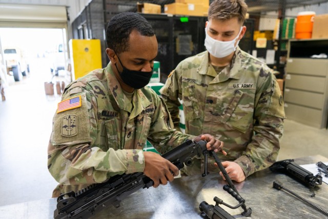 Staff Sgt. Nahjier Williams, public affairs noncommissioned officer, 1st Theater Sustainment Command, teaches Spc. James Spoerl, human resources specialist, 1st Theater Sustainment Command, how to properly disassemble an M249 Squad Automatic Weapon at  Fort Knox, Kentucky, February 26, 2021 in preparation for the Best Warrior Competition. The Best Warrior Competition The Best Warrior Competition recognizes Soldiers who demonstrate commitment to the Army values, embody the Warrior Ethos, and represent the Force of the Future. (U.S. Army photo by  Spc Owen Thez, 1st TSC PAO)