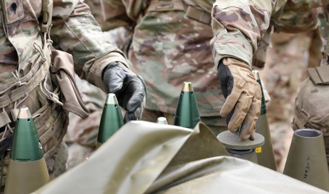 U.S. Army Soldiers from 1st Battalion, 319th Airborne Field Artillery Regiment, 3rd Brigade Combat Team, 82nd Airborne Division, prepare 155 mm shells for loading during a live fire exercise in support of Swift Response 21 at Tapa Central Training Area, Estonia, May 10, 2021. Swift Response 21 is a linked exercise of DEFENDER-Europe 21, which involves special operations activities, air assaults, and live fire exercises in Estonia, Bulgaria, and Romania, demonstrating airborne interoperability among NATO allies and partners. DEFENDER-Europe 21 is a large-scale U.S. Army-led exercise designed to build readiness and interoperability between the U.S., NATO allies and partner militaries. This year, more than 28,000 multinational forces from 26 nations will conduct nearly simultaneous operations across more than 30 training areas in more than a dozen countries from the Baltics to the strategically important Balkans and Black Sea Region. Follow the latest news and information about DEFENDER-Europe 21, visit www.EuropeAfrica.army.mil/DefenderEurope. (U.S. Army photo by Staff Sgt. Michael Gresso).