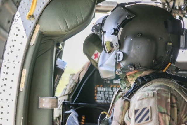 U.S. Army Sgt. Matthew Hankey, a UH-60 Black Hawk helicopter crew chief assigned to 3rd Combat Aviation Brigade, 3rd Infantry Division, scans his sector during an aerial gunnery exercise, April 27, 2021, on Fort Stewart, Georgia. Aerial gunneries...